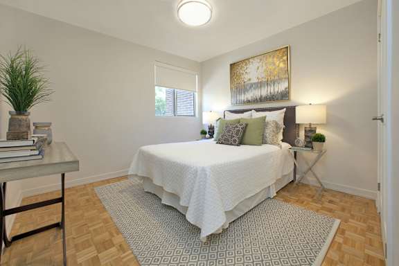 a bedroom with a bed and a window