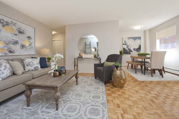 a living room with a couch and a table   and a dining room table