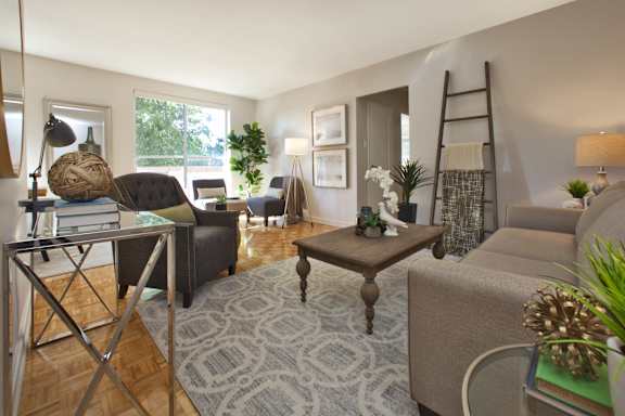 a living room with couches and chairs and a table