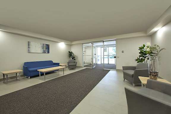 a living room with blue couches and chairs and a rug