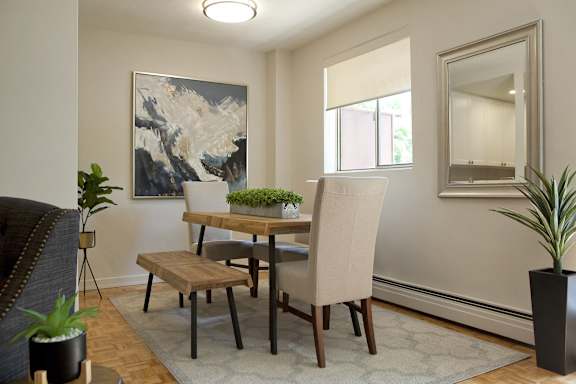 a dining room with a table and chairs and a window