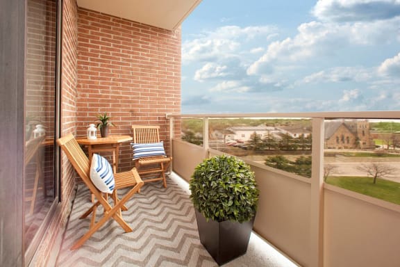 a balcony with a table and chairs on it