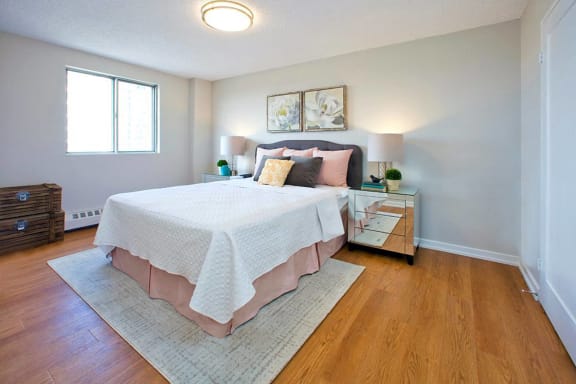 a bedroom with a bed and a night stand