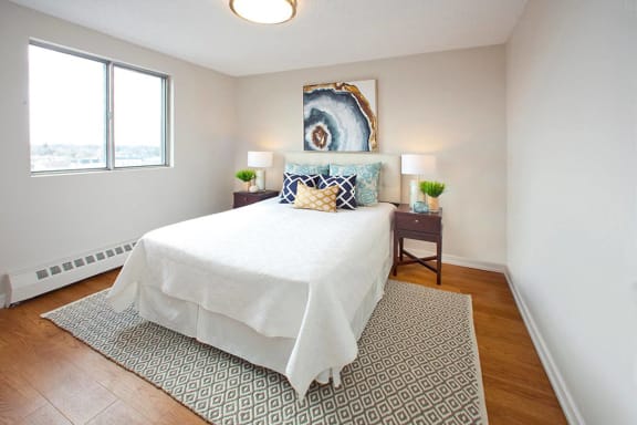 a bedroom with a bed and a window