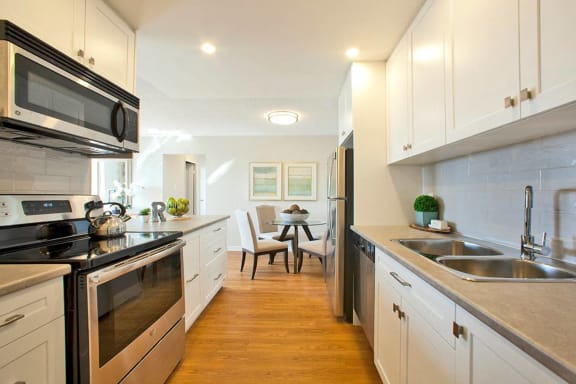 a kitchen with stainless steel appliances and white cabinets