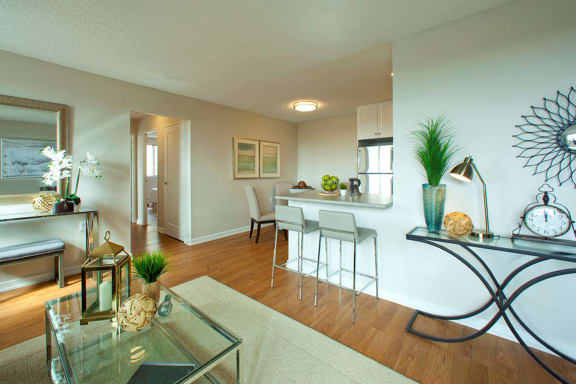 a living room and a kitchen with a table and chairs