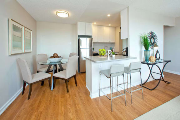 a kitchen and dining area with a table and chairs