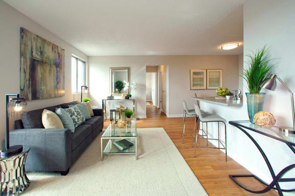 a living room with a couch and a glass table