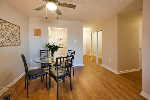 a dining room with a table and chairs and a ceiling fan
