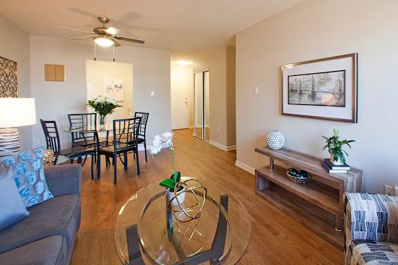 an open living room and dining room with a glass table