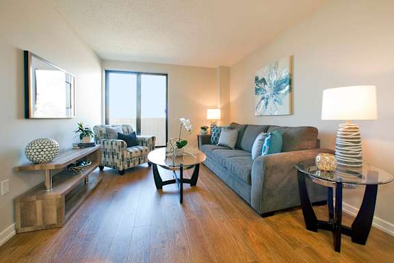 a living room with a couch and a chair and a table