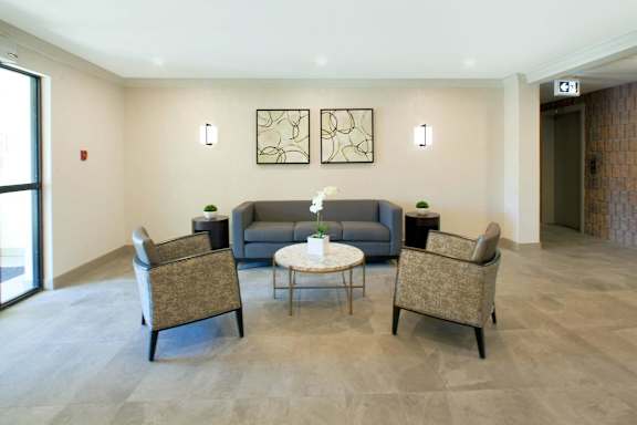 a living room with couches and chairs and a table