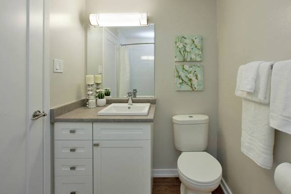 a small bathroom with a toilet sink and mirror