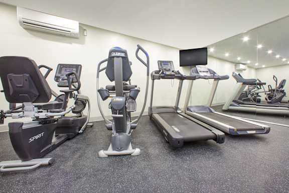 a gym with treadmills and cardio equipment in a building