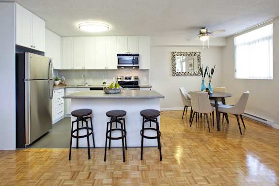 an open kitchen and dining area with a table and chairs