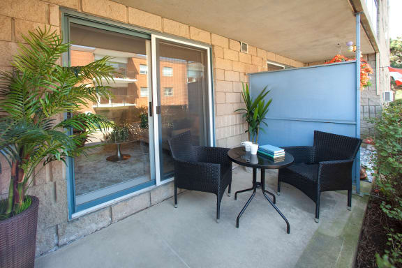 a patio with chairs and a table on a patio