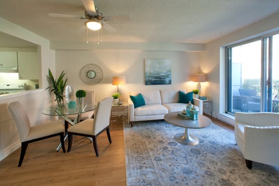 a living room with a couch and a table and a ceiling fan