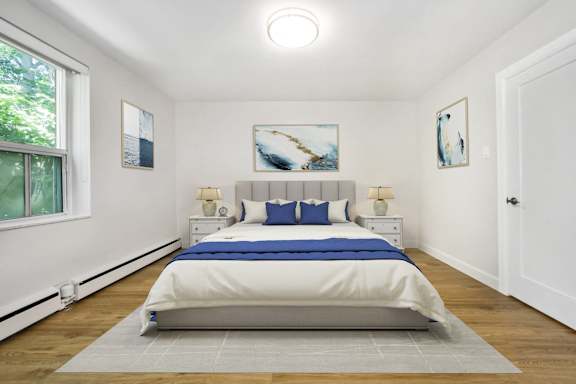 a bedroom with a large bed and two windows
