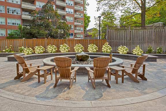 a patio with a table and chairs and a fountain