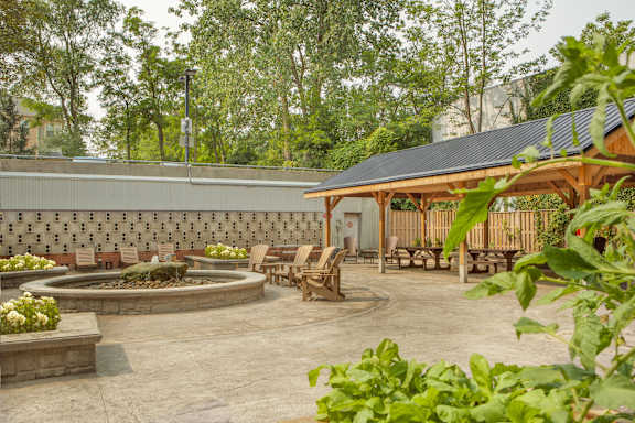 a patio with tables and chairs and a fountain