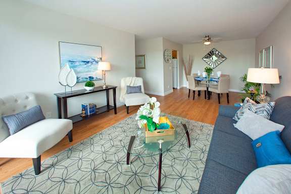 A living room with a grey couch and a coffee table in the middle.