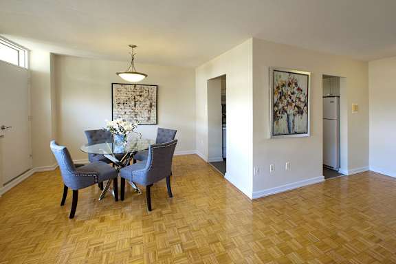 a dining room with a table and chairs and a hard wood floor