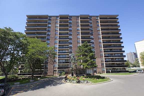 an empty parking lot in front of an apartment building