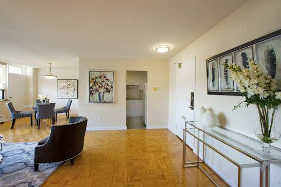 a living room and dining room with a table and chairs