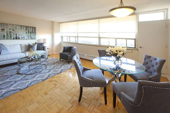 a living room with a glass table and a couch
