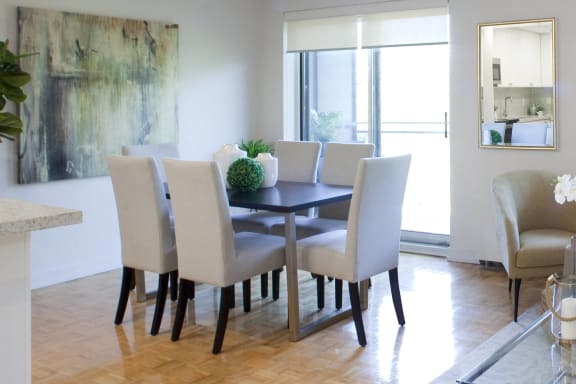 an image of a dining room with a table and chairs
