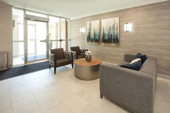a living room with a couch and chairs and a coffee table