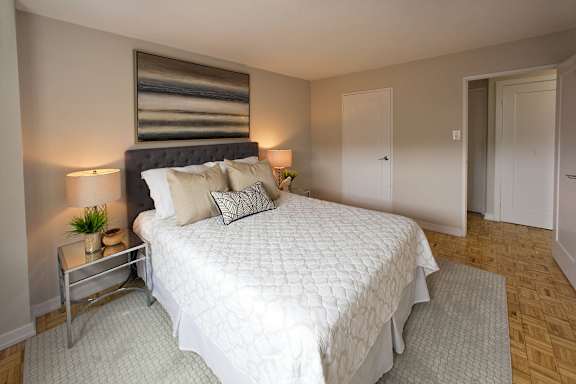 a bedroom with a large white bed and a window
