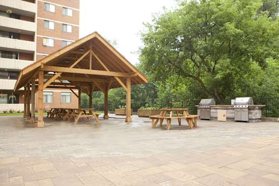 a pavilion with picnic tables in a park