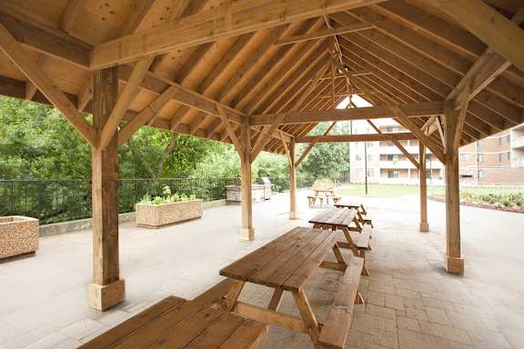 a picnic area with benches and a roof