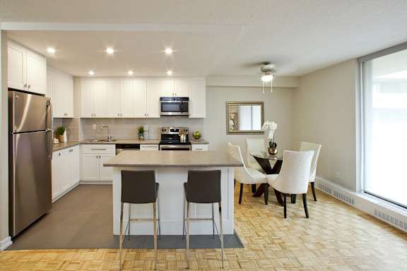 an open kitchen and dining room with a table and chairs