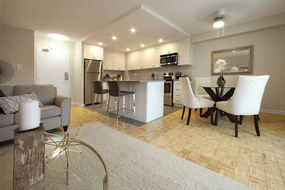 a living room and kitchen with a table and chairs