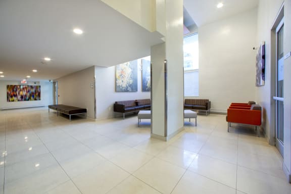 a view of the lobby of a building with couches and chairs