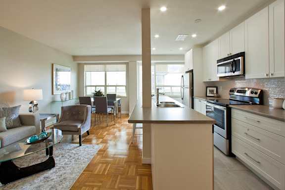 a living room with a kitchen and a dining room