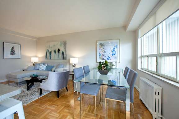 a living room with a glass dining table and a couch