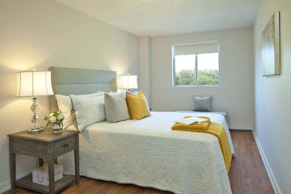 a bedroom with a large bed and a window