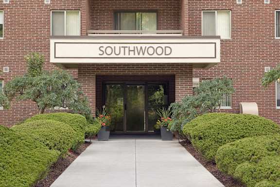 the front of the southwood building with a sidewalk