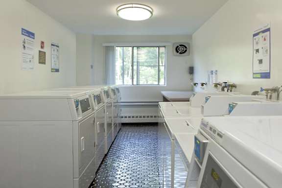 a washer and dryer laundry room with white machines and a window