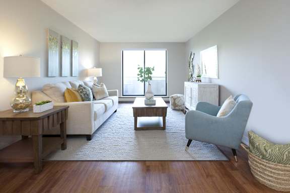 a living room with a couch and a chair and a table