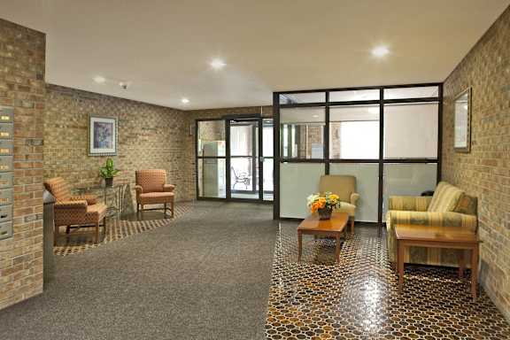 a living room with furniture and a glass door