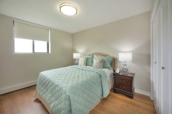 a bedroom with a large bed and a window