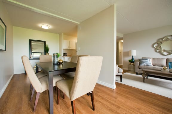 a dining room and living room with a table and chairs