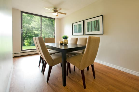 a dining room with a table and chairs and a window