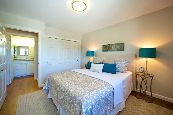 a bedroom with a bed and a door to a bathroom