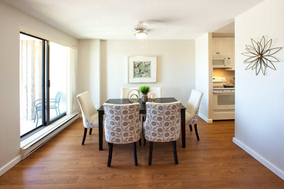 a dining room with a table and chairs and a window
