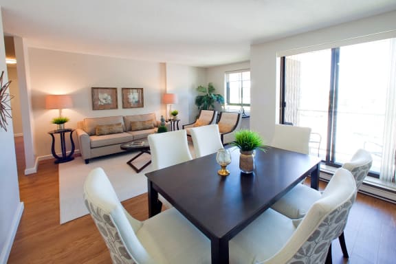 a living room and dining room with a table and chairs